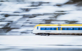 A cinematic view of a high-speed ICE 1 train speeding through a snowy landscape.