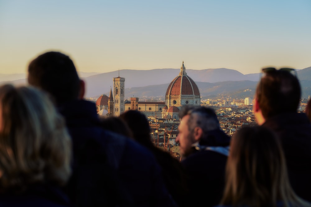 a group of people standing in front of a city