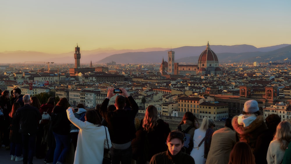 a crowd of people standing on top of a tall building