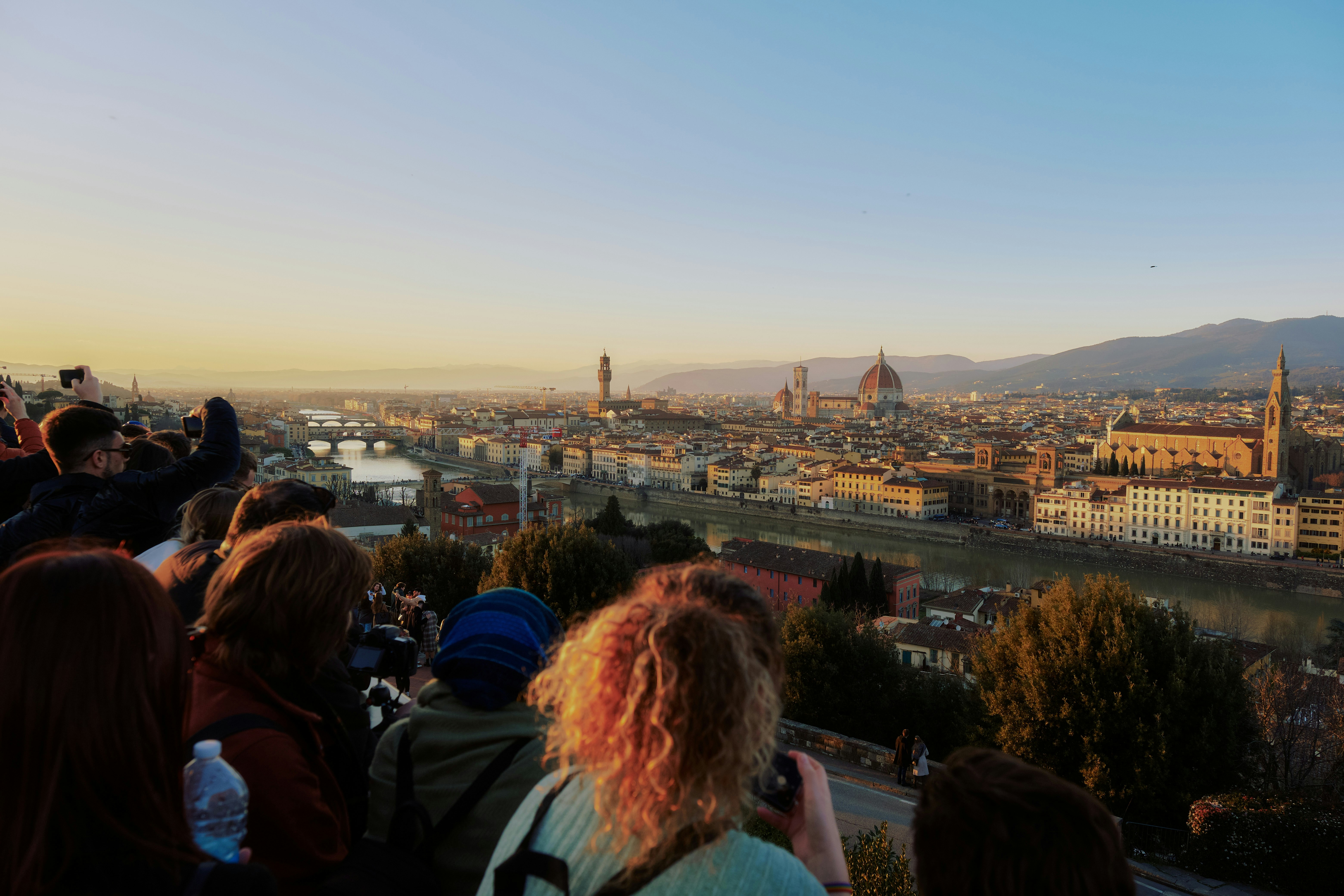 a group of people standing on top of a hill, 