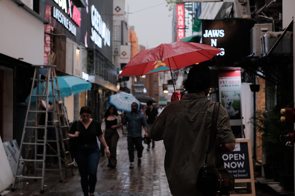 a woman walking down a street holding an umbrella