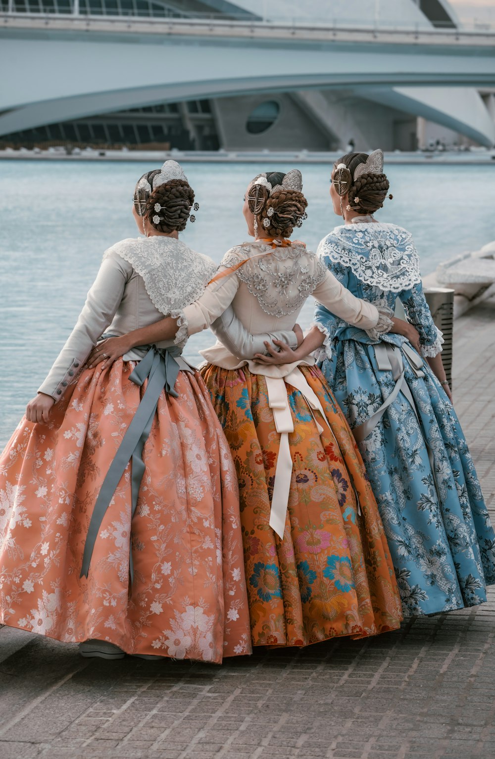 a group of three women standing next to each other