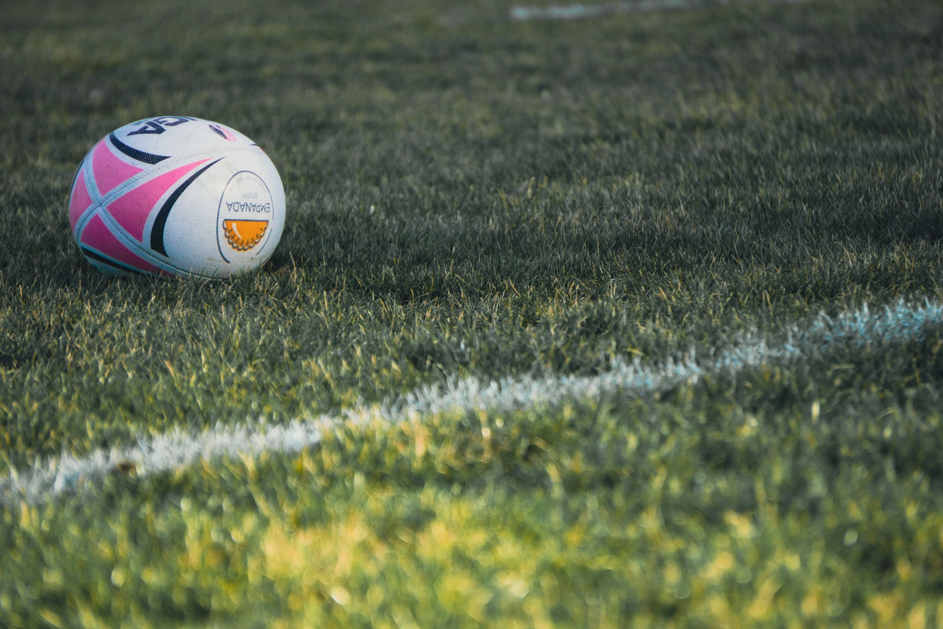 a soccer ball sitting on top of a lush green field