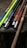 A colorful assortment of handmade LARP swords displayed on a wooden table.