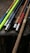 A colorful assortment of handmade LARP swords displayed on a wooden table.