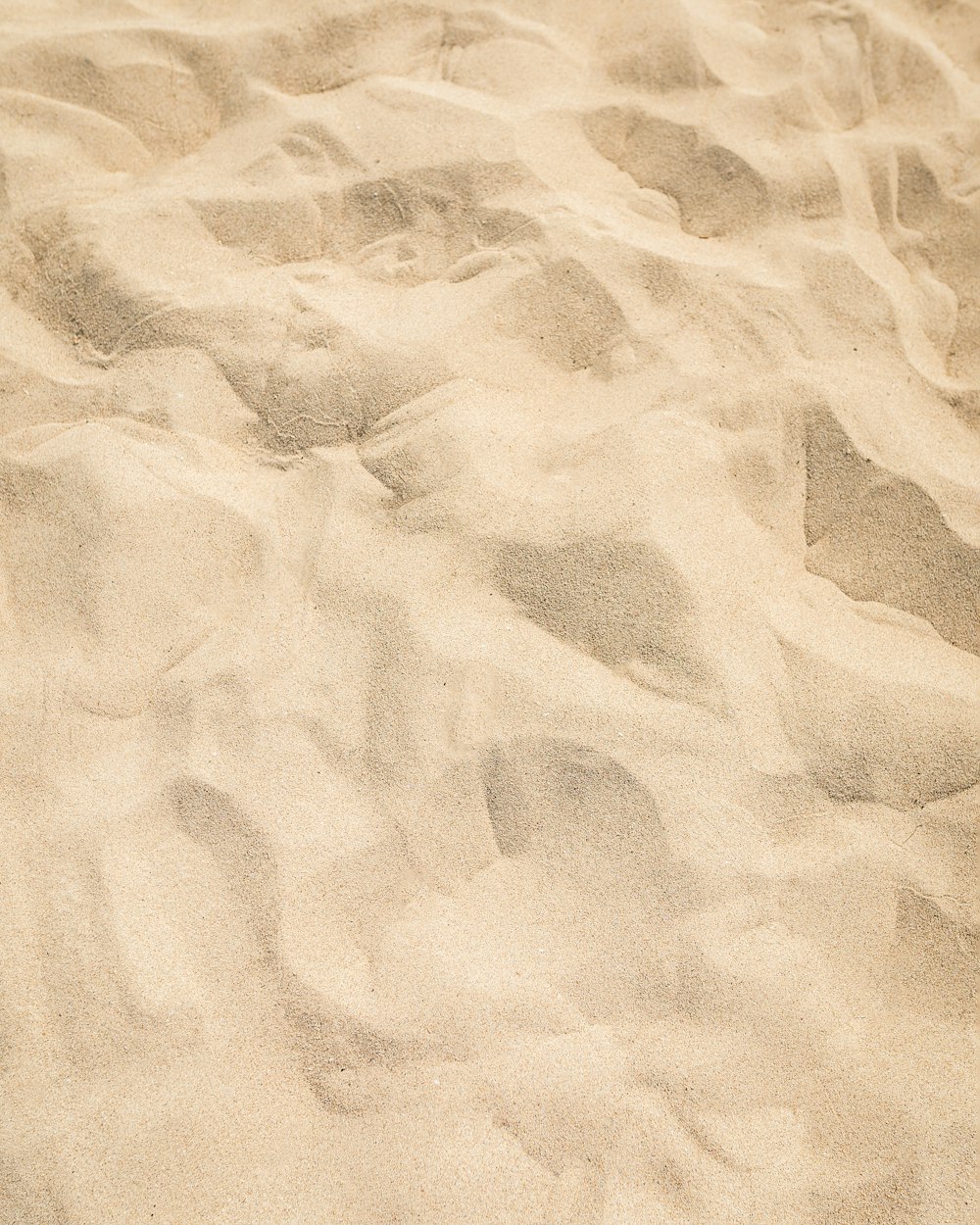 a surfboard laying in the sand on a beach