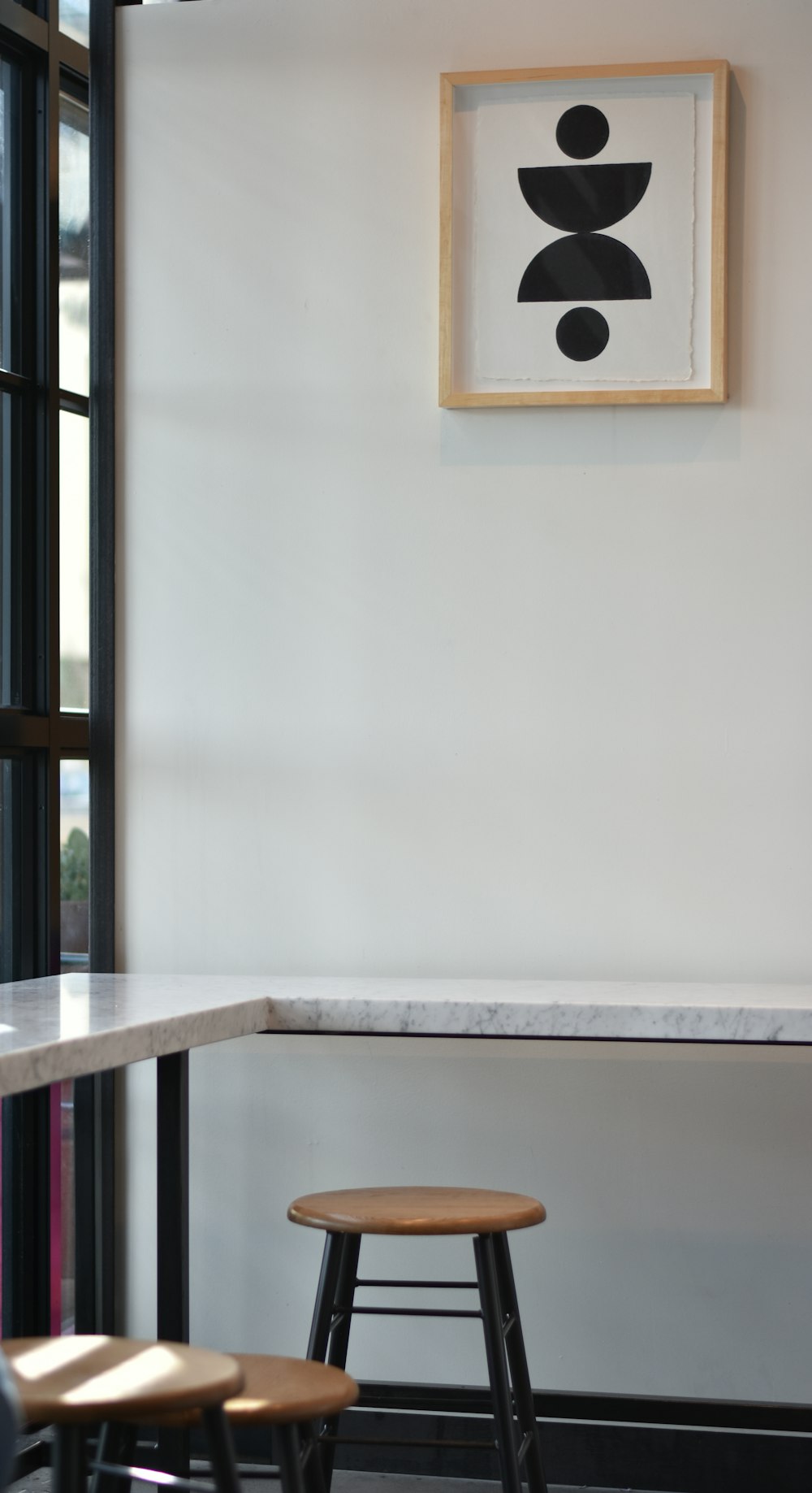 two stools sit in front of a white counter