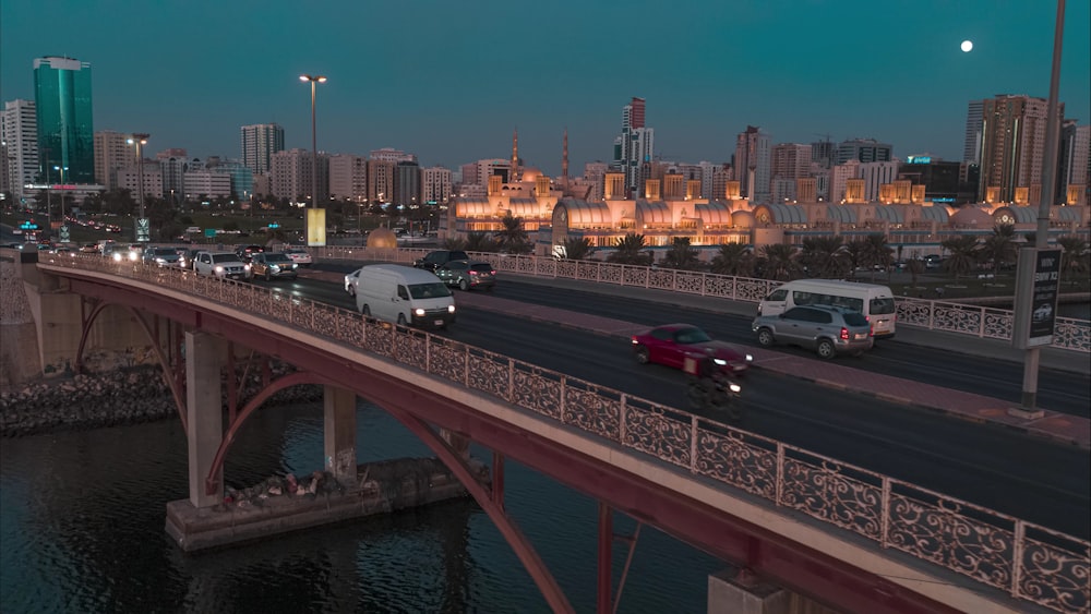 a bridge over a river with cars driving on it