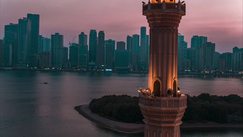 a tall clock tower sitting in the middle of a lake