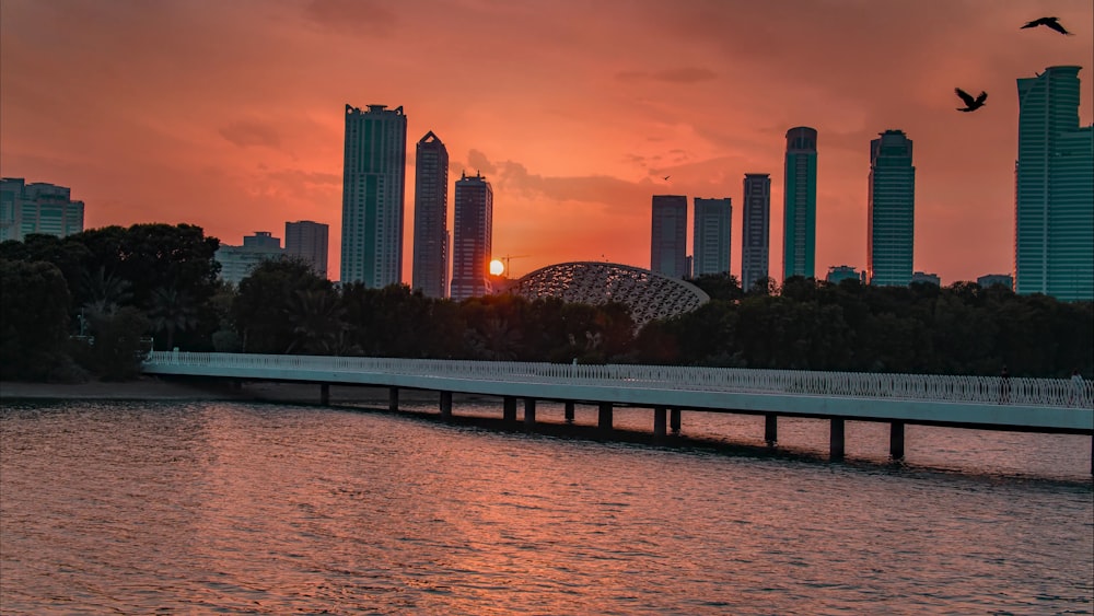 the sun is setting over the city skyline