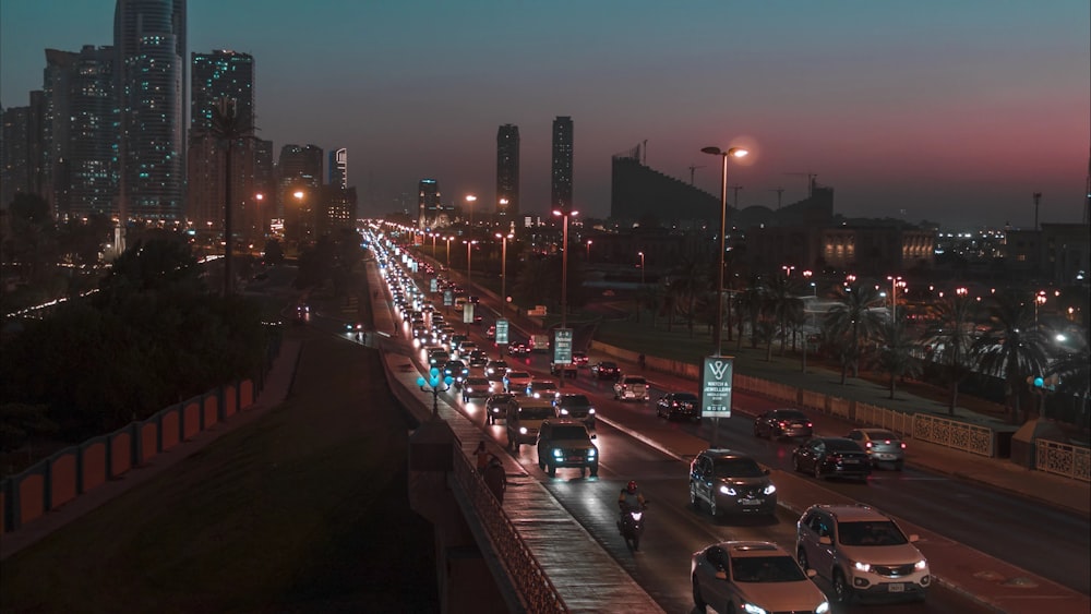 a city street filled with lots of traffic at night