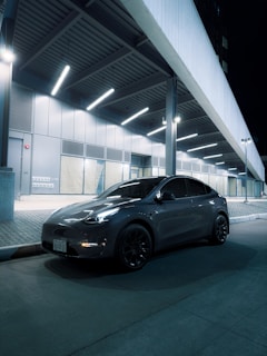 a car parked in front of a building at night