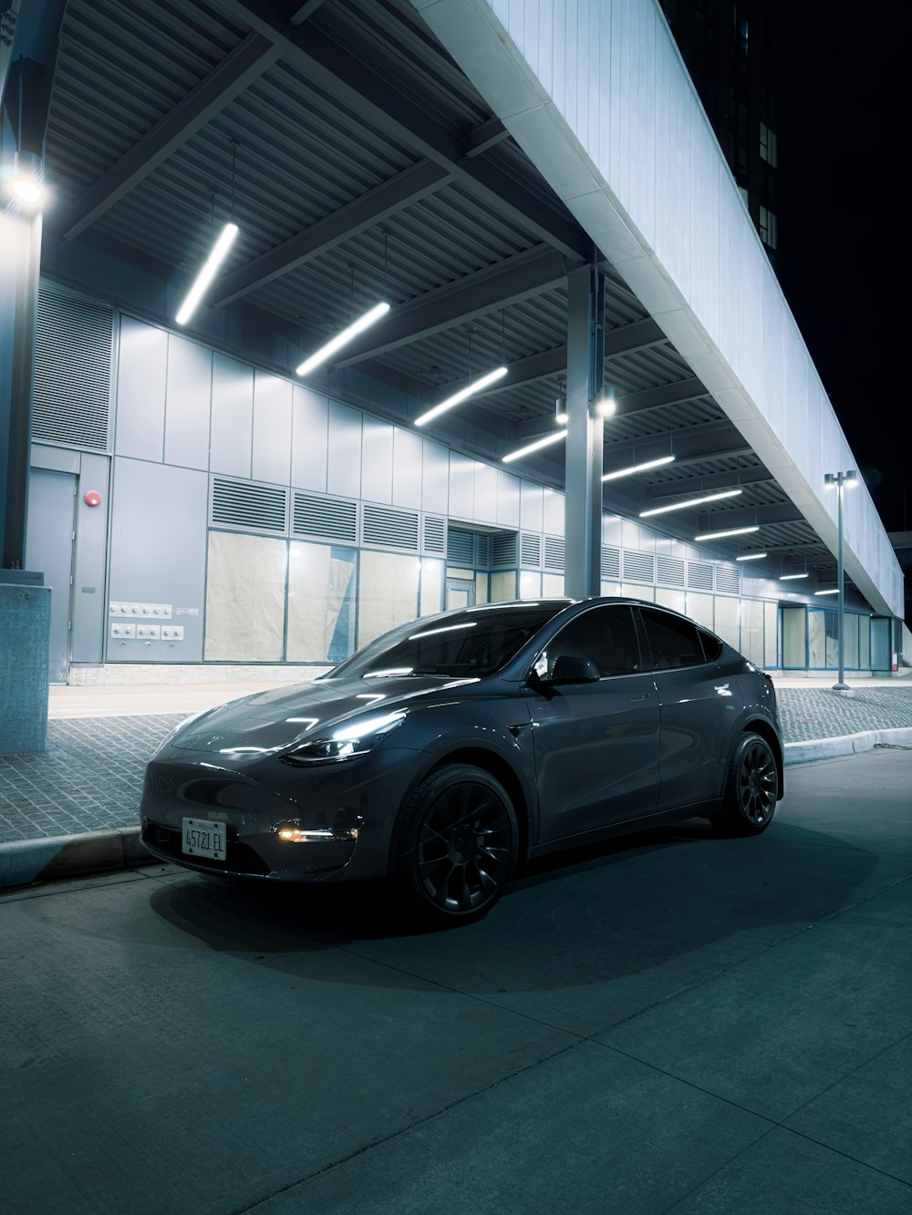 a car parked in front of a building at night