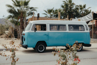 a blue and white van parked on the side of the road