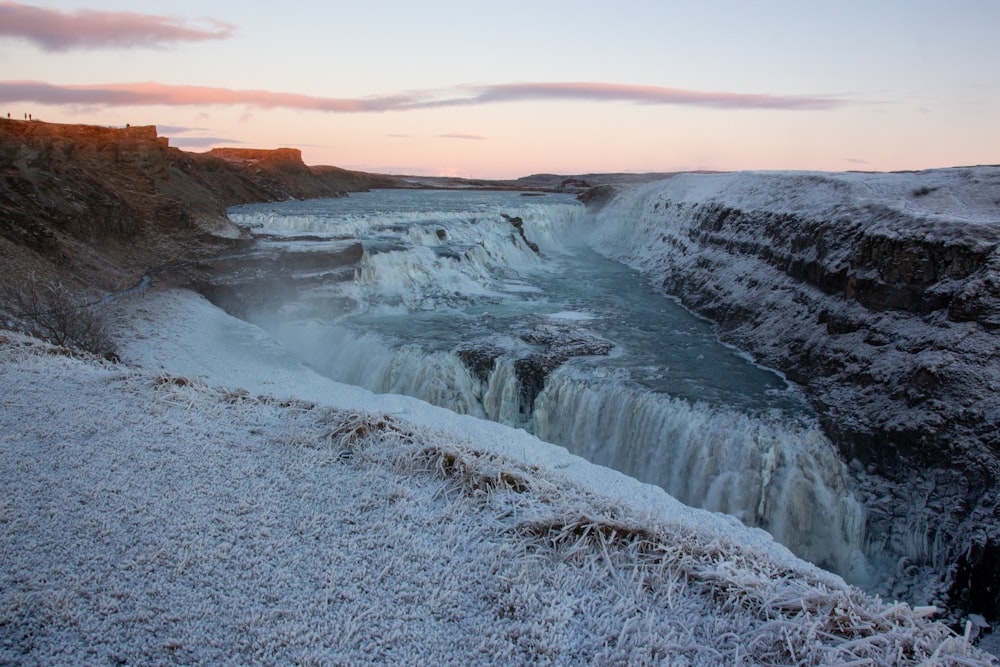 a frozen waterfall in the middle of a mountain