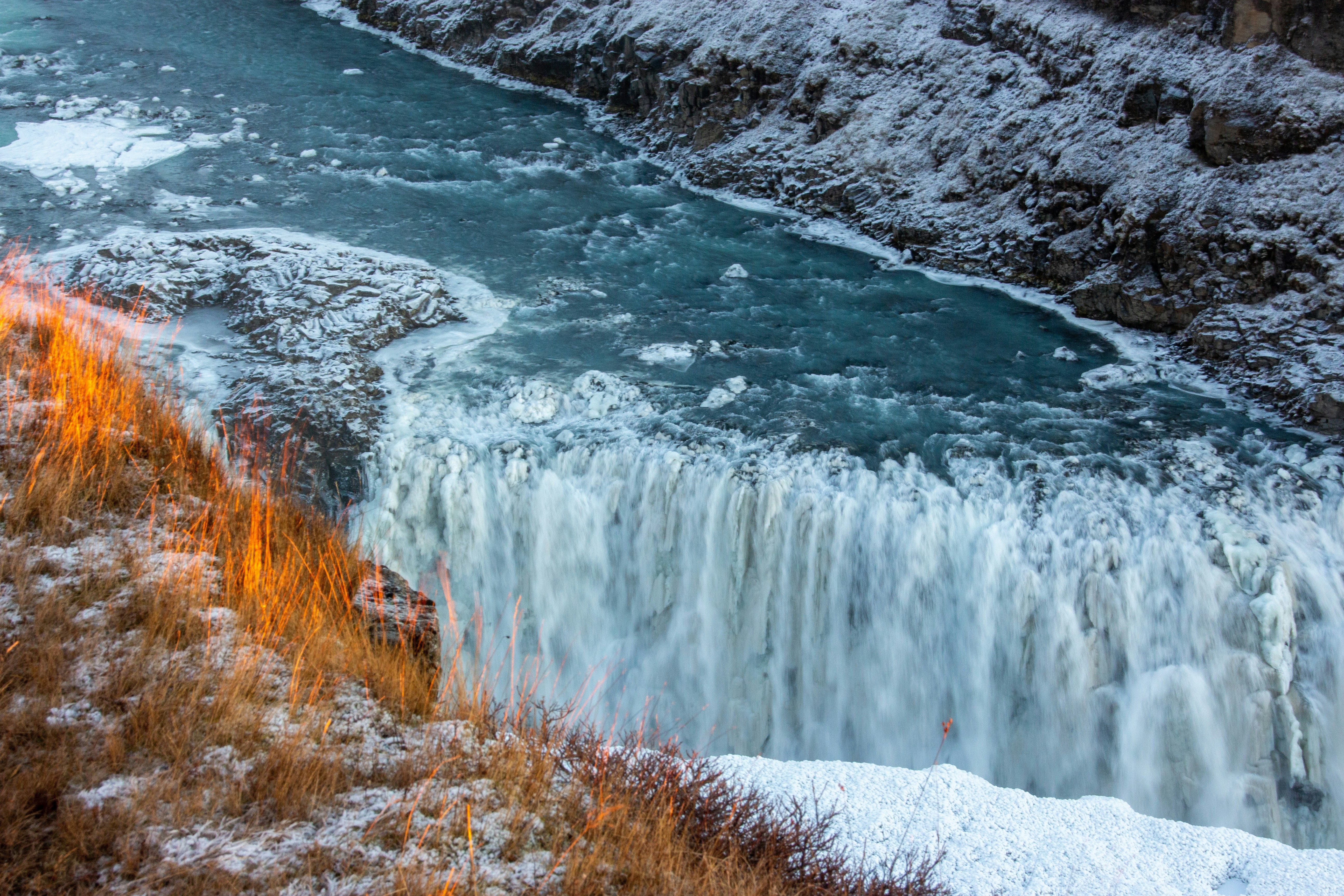 A large waterfall with a bunch of water coming out of it photo – Free ...