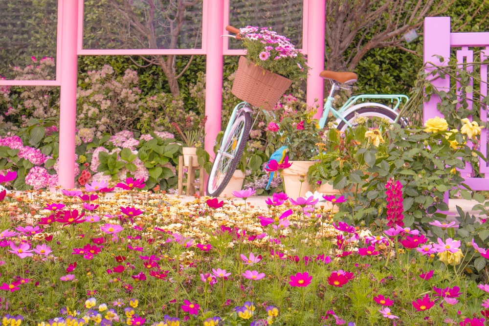 a bike is parked in a flower garden