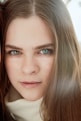 a woman with long hair and blue eyes