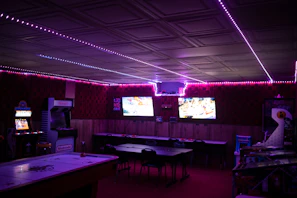 Modern gaming lounge with comfortable seating and vibrant LED lighting.