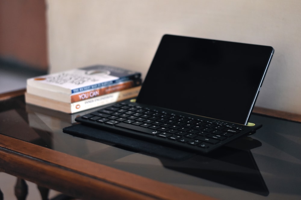 a laptop computer sitting on top of a wooden table