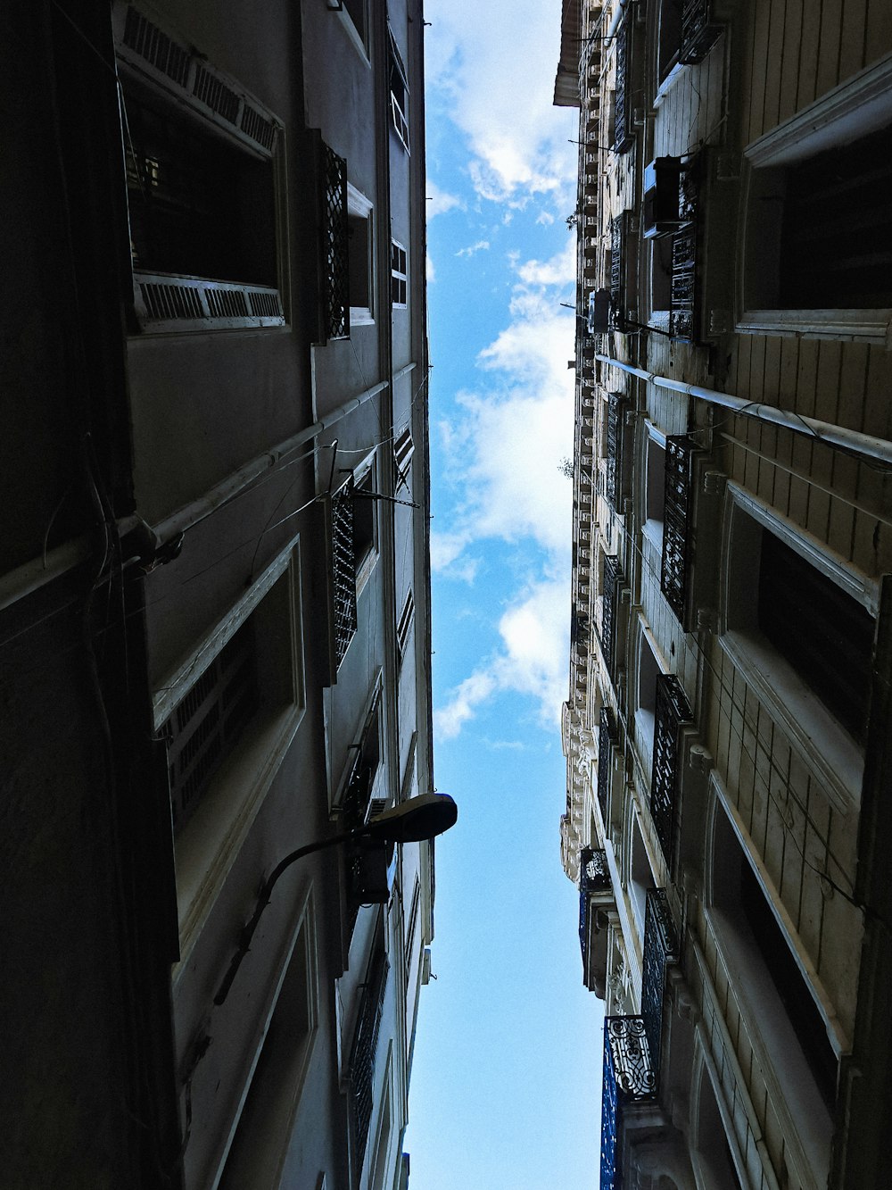 looking up at the sky between two buildings