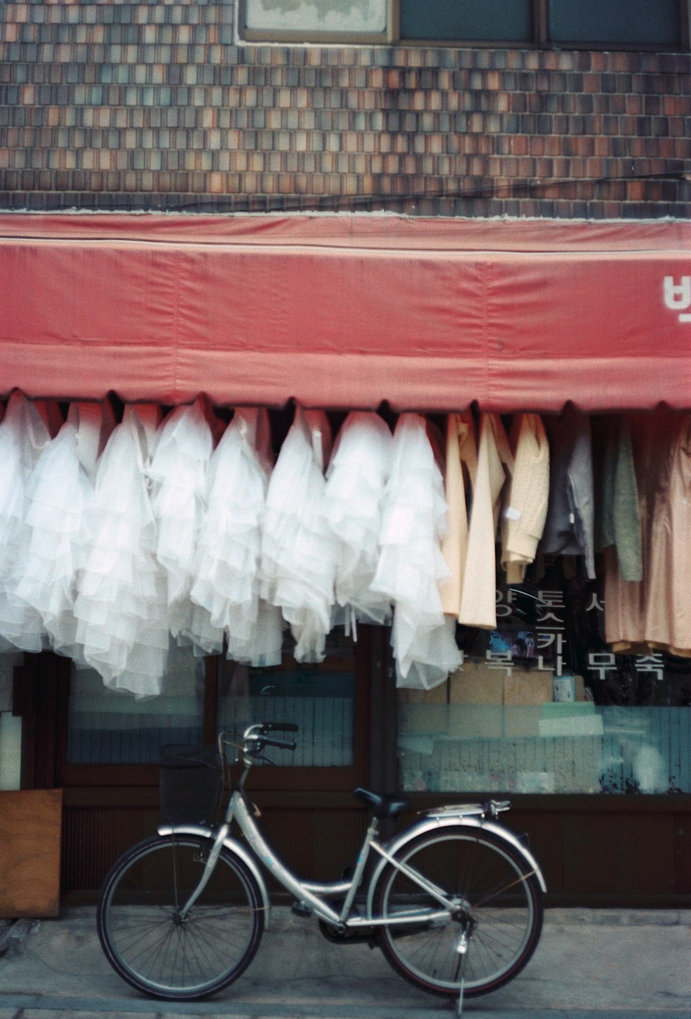 a bicycle parked in front of a clothing store