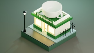 A stylized miniature building resembling a tea shop, topped with a large teacup. The structure is primarily green and white, featuring a lit window and surrounded by a small black fence. A streetlight stands next to the building, casting a soft glow.
