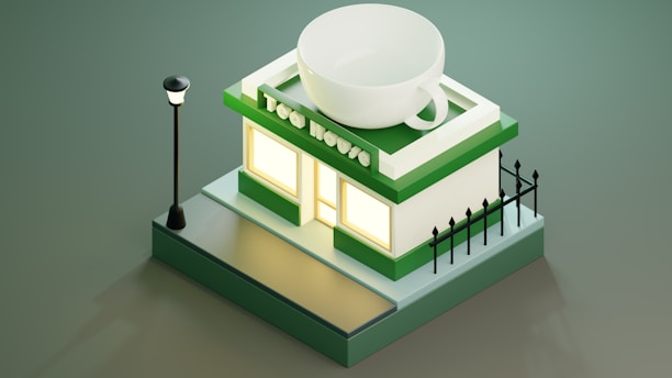 A stylized miniature building resembling a tea shop, topped with a large teacup. The structure is primarily green and white, featuring a lit window and surrounded by a small black fence. A streetlight stands next to the building, casting a soft glow.