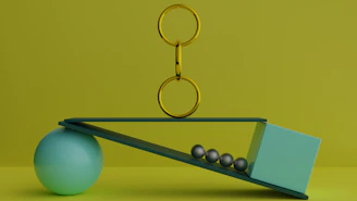 a ball and a pair of scissors on a scale