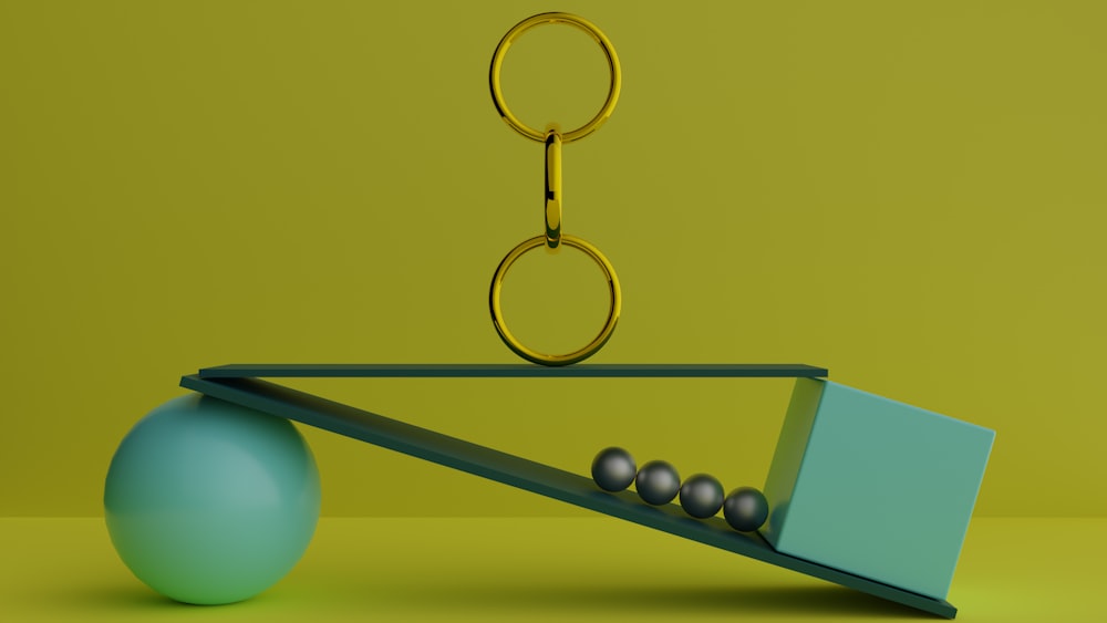 a ball and a pair of scissors on a scale