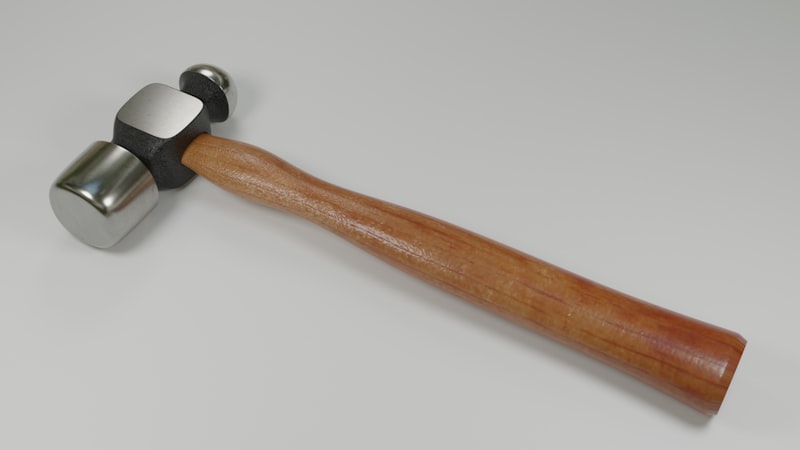 a hammer with a wooden handle on a white surface