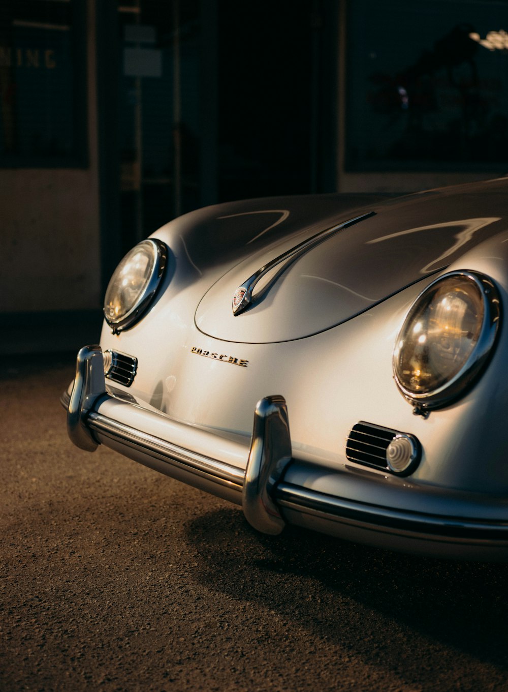 a close up of the front of a silver sports car