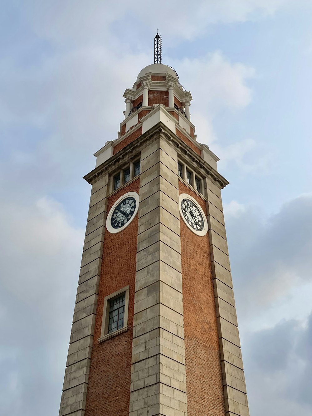 a tall brick clock tower with a clock on each of it's sides