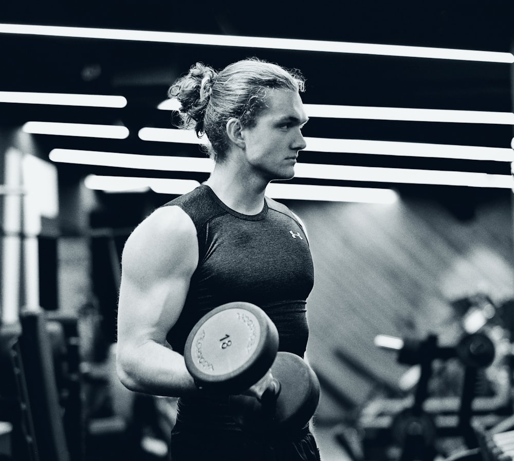 a woman holding a disc in a gym