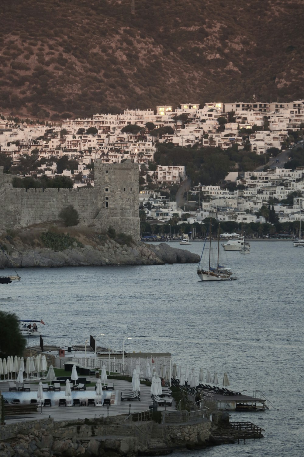 a body of water with a city in the background