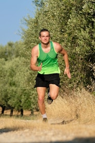Active man running outdoors in the sunrise, showcasing energy and vitality.