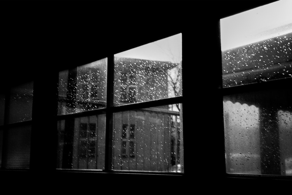 a black and white photo of a rainy window