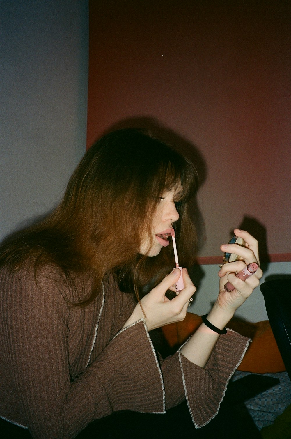 a woman holding a toothbrush in her mouth