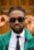 a man wearing sunglasses and a green jacket