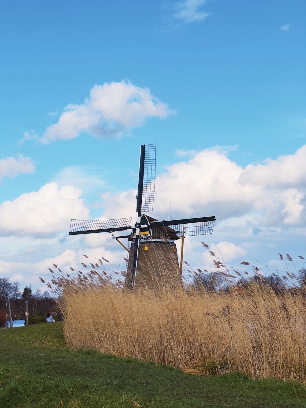 a windmill in a field of tall grass