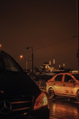 Night view of a taxi cruising smoothly through Al Wafrah’s agricultural area.