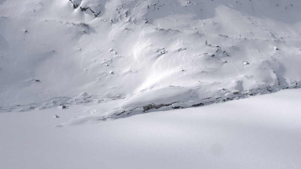 a man riding skis down a snow covered slope