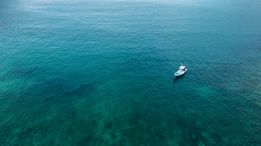 a small boat floating on top of a large body of water