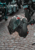 Artistic side view of a Buchtriders helmet resting on a vintage motorcycle tank