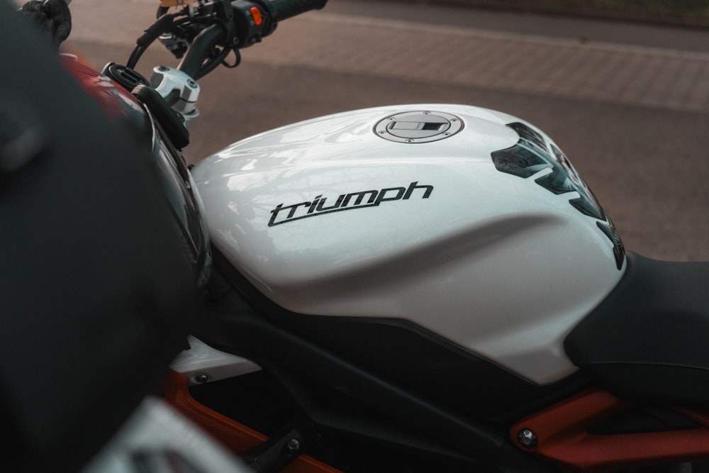 a white and black motorcycle parked on the side of the road