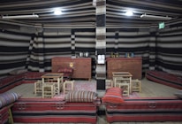 A cozy kına night setup with traditional cushions and vibrant decorations.