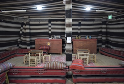 A cozy kına night setup with traditional cushions and vibrant decorations.