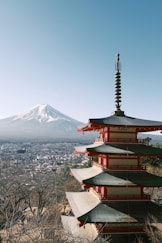 a pagoda with a mountain in the background