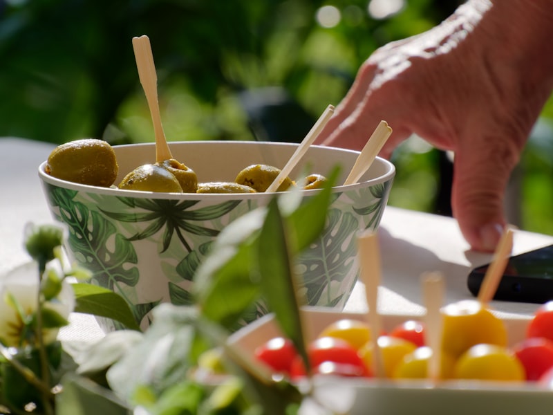 a bowl filled with olives and peppers on a table from unsplash}