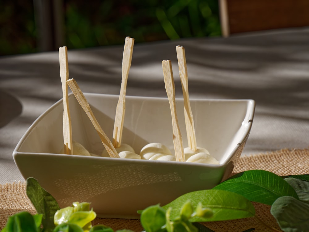 toothpicks are placed in a bowl on a table